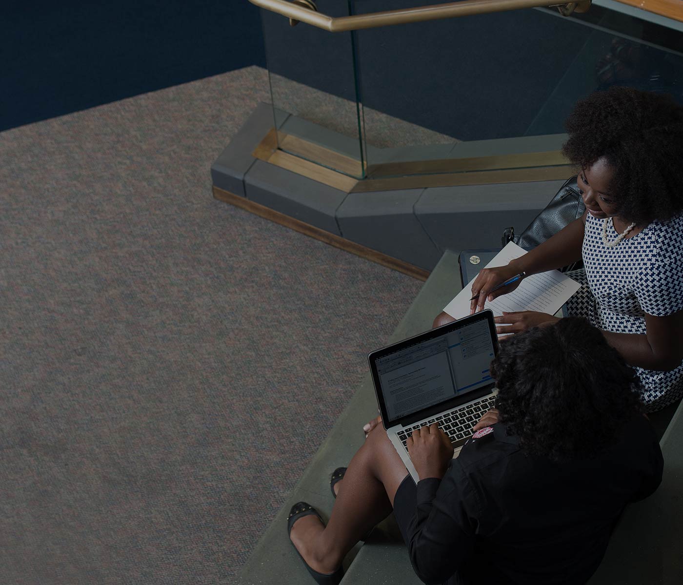Student coaching on the library steps