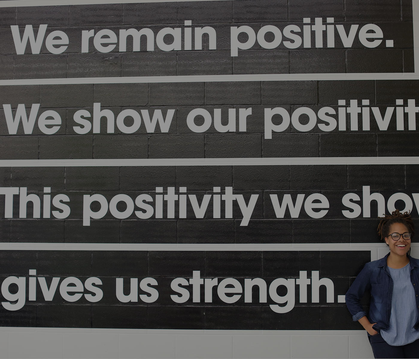 Girl standing in front of mural