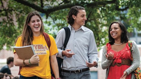 Students walking on campus having fun.